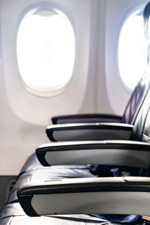 Black leather seats for passenger in economy class cabin and the seat belt for securing. belt for securing.の写真素材