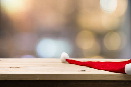 Selective focus Christmas holiday background with Santa hat. bokeh abstract background - can be used for montage or display your productsの写真素材