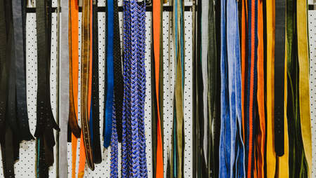 Rows of colorful belts in the shop for men and women. Can be used for background.の写真素材