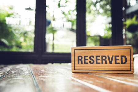 Reserved sign on a restaurant wooden table.の写真素材