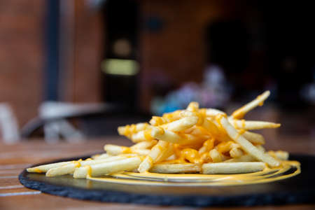 Wood table with appetizer and light reflection on scene at restaurant, pub or bar. Blurred background for product display with several concept idea.の写真素材