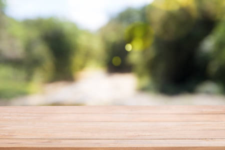 Wooden board empty table in front of blur Abstract natural green light background. Using for Mock up template for display of your design,Banner for advertise of product.の写真素材