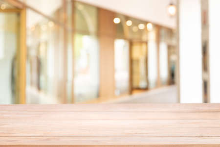 Empty of wood table with blur The walk way or corridor in the building for shopping or modern office...
