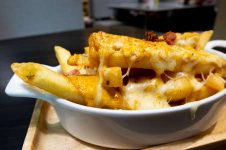 Selective focused of french fries as appetizer and light reflection on scene at restaurant, pub or bar at night. Blurred background for product display with several concept idea. - Imageの写真素材