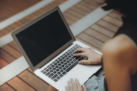 Blank screen for presentaton with Beautiful young Asian girl working at a college with a laptop. female freelancer connecting to internet via computer.の写真素材