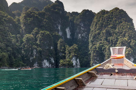 Long tail boats carry tourist heading to island in Thailand.