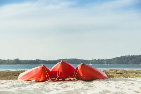 Red kayaks on the tropical beach, Active rest, sport. A few cannoe stand on a sandy beach. summer conceptの写真素材
