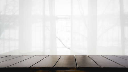 Empty of wood table with Blur curtain window and stationery box with sunlight. Using for Mock up...