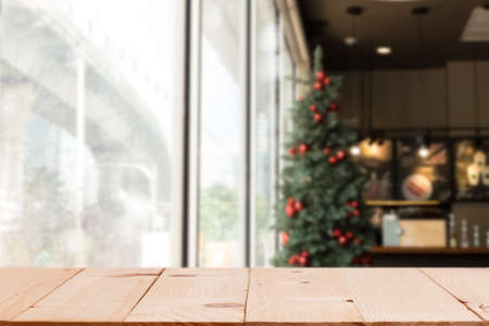 Empty wood table top with xmas tree of winter season background.For christmas day and new year...