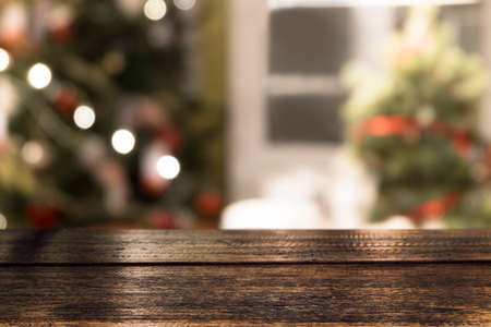 Empty wooden table top and christmas hat over festive bokeh light decorate on tree. For create montage product display. Christmas holiday backgroundの写真素材