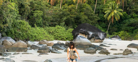 Abstract Young woman in casual style fashion walk on the beach. Relaxing and enjoy holiday at tropical paradise beach. Girl in summer vacation. Summer vibes.の写真素材