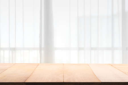 Empty of wood table with Blur of curtain window. For montage product display or design key visual layout.の写真素材