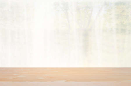 Empty wood table wiht defocused curtain window and stationery box with sunlight. Using for Mock up template for display of your design or design key visual layout.の写真素材