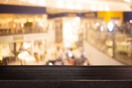 Empty wood table with Blur coffee shop or cafe restaurant with abstract bokeh light image background. For create montage product display. modern lifestyle background.の写真素材