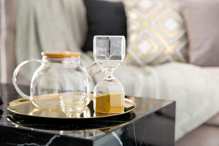 Stylish scandinavian composition of marble console with jar tea and accessories. Modern composition...