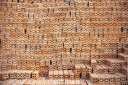 A group of construction brick or Pile of clay bricks put in neat order, used for construction material store outdoor at building site. Construction concept with copy space and room for text.の写真素材