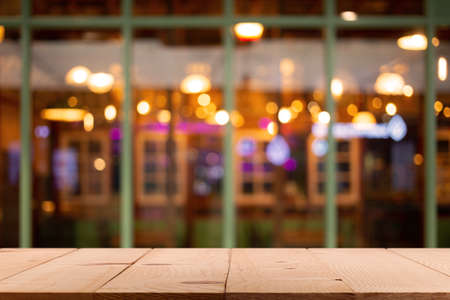 Empty wooden bar counter with defocused background and restaurant, bar or cafeteria background /for your product displayの写真素材