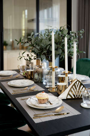 Modern scandinavian living room interior with dining table with mable plates and muffin, design...