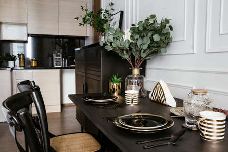 Modern scandinavian make up table interior with black and white, design commode, leaf in vase, cozy pillow, and elegant accessories. Template. Stylish home decor.の写真素材