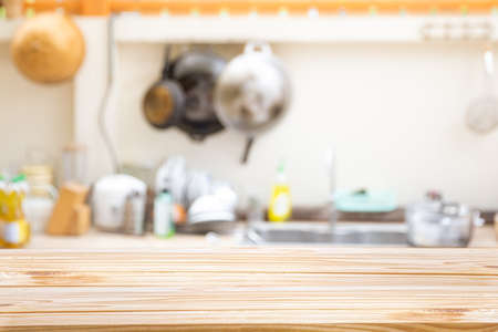 Wooden board empty table in front of Blur image of traditional Kitchen Room interior - can be used for display or montage your products.Mock up for display of product.の写真素材