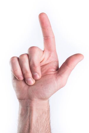 Man's hand miming gun on white backgroundの写真素材