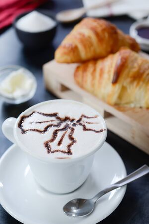 Cappuccino decorato e croissantの写真素材