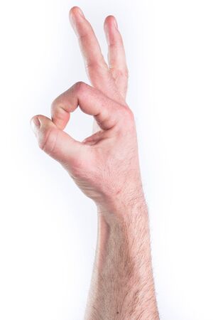 Man's hand miming OK on white backgroundの写真素材