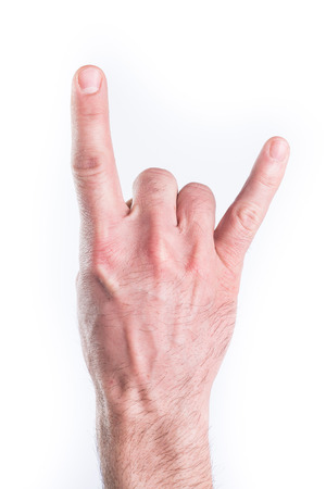 Man's hand miming horns on white backgroundの写真素材