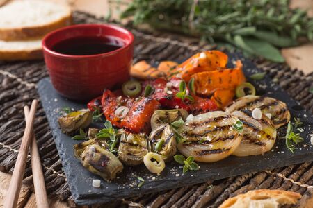 Grilled seasonal vegetables dressed with herbs, balsamic winegar and olive oilの写真素材