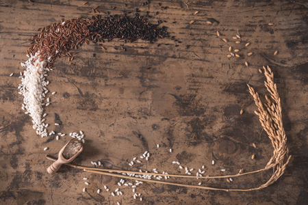 Top view rice composition in a frame with raw rice on wood backgroundの写真素材