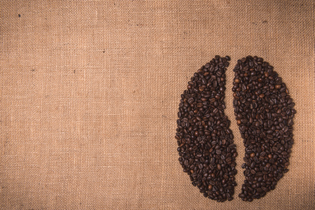 portrait toasted coffee shape beans top view on juta textileの写真素材