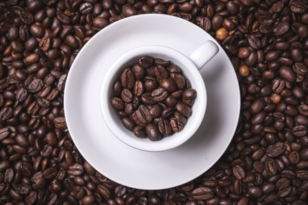 top view coffee cup fille dwith coffee beans on backgroundの写真素材
