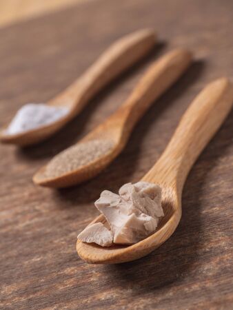 dry yeast, fresh yeast and instant yeast on top view wood table compositionの写真素材