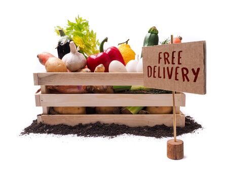 Organic vegetables in wooden rustic box and topsoil with cardboard square tag. Price tag, gift tag, sale tag,  label isolated on white backgroundの写真素材