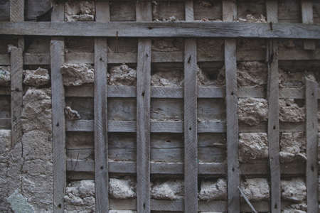 Grungy grey brown old wall background texture. Abandoned, depressive, post-apocalypse atmosphere.の写真素材