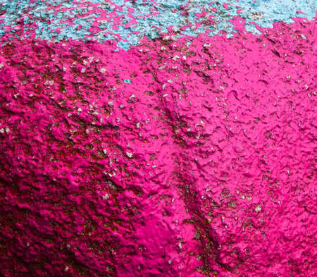 Old painted granite stone rock background. Pink, fuchsia, blue, cyan, turquoise, aquamarine, redの写真素材