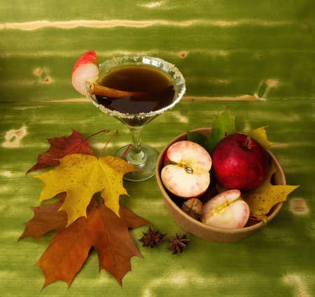 Autumn fall Halloween Thanksgiving season special martini cocktail. A photo composition with maple...