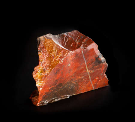 Red beautiful jasper mineral crystal from Orsk, Ural, Russia. A photo of a stone isolated on black. For geology or mineralogy websites, stone collection catalog, Natural Science museum wall charts.の写真素材