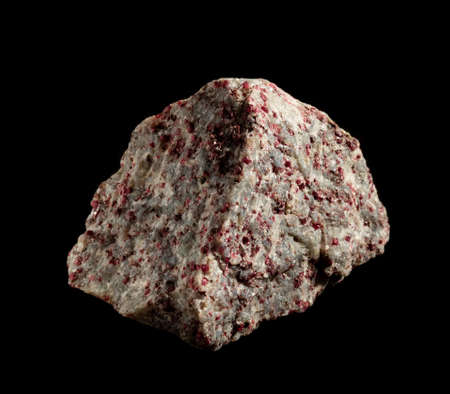 Garnet almandine crystal blotches inside rock. A mineral isolated on black. Found near Miass city, Ural, Russia. Geology mineralogy websites, stone catalog, Natural Science museum wall chart.の写真素材