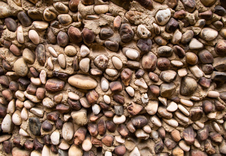 Yellow orange warm pebble stone wall abstract background texture