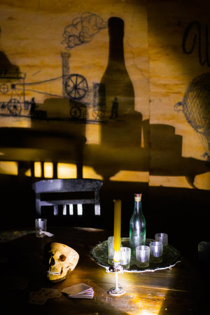 Odessa, Ukraine - 04 21 21: Catacombs Museum. A composition with skull, playing cards, bottles and...