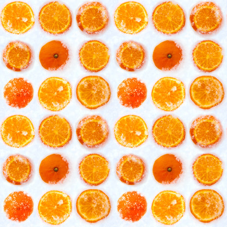 Slices of fresh orange tangerine fruit cowered with white cold winter snow seamless pattern. Bright...