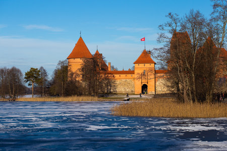 Trakai, Lithuania - 01 08 22: Island Castle in winter in sunny weather, lake covered with iceのeditorial素材