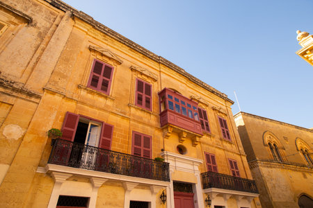 Mdina, Malta - 12 15 22: yellow sandstone facades and traditional maltese balconiesのeditorial素材