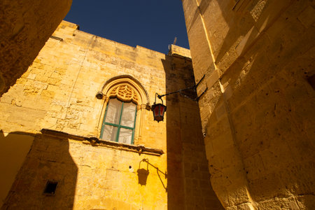 Mdina, Malta - 12 15 22: yellow sandstone facades of old buildingsのeditorial素材