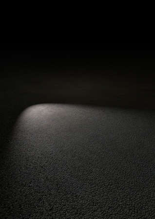 Spotlight shining on asphalt tar roadの写真素材