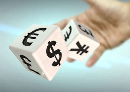 Hand throwing 2 dice with currency symbols. Concept for financial advice, trading, markets. Strong depth of field.の写真素材