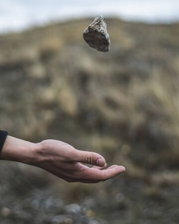 Stone hovering above handの写真素材