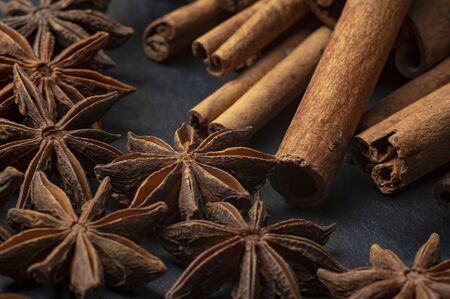 Brown star anise and cinnamon on a dark backgroundの写真素材