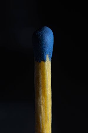 match with a blue head isolated on a dark background